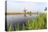 Green Grass Frames the Windmills Reflected in the Canal, Netherlands-Roberto Moiola-Stretched Canvas