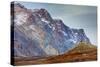 Greenland. Kong Oscar Fjord. Ella Island. Hiker dwarfed by rocky mountains.-Inger Hogstrom-Stretched Canvas