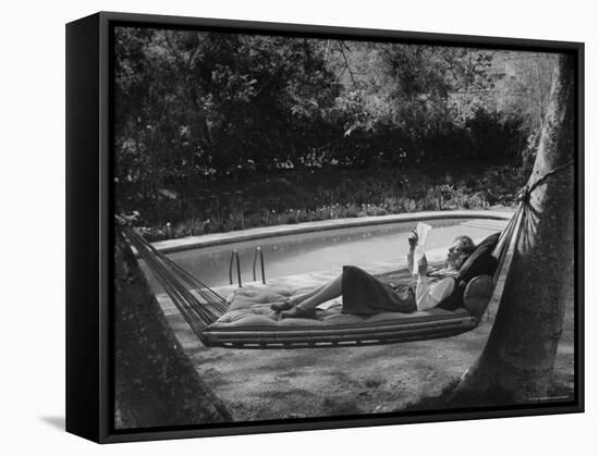 Greer Garson Reading While Relaxing in a Hammock Near Her Pool at Home-Peter Stackpole-Framed Stretched Canvas