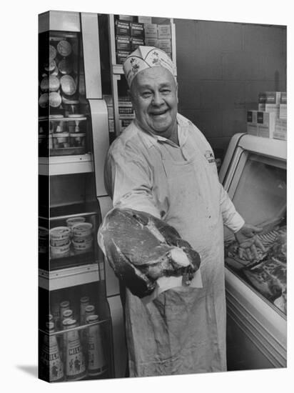 Grocer E.G. Guthart Displaying One of His Steaks-Francis Miller-Stretched Canvas