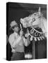 Groom Cleaning Horse's Teeth During Filming of the Movie "The Ziegfeld Follies"-John Florea-Stretched Canvas