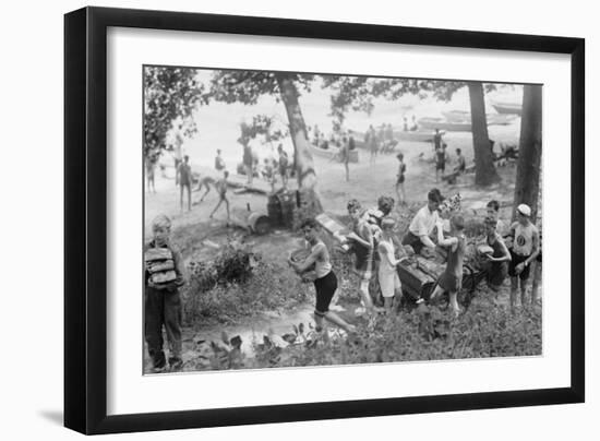 Group of Boys Carry Loaves of Bread from Wagons Near Beach Front in Woods.-null-Framed Art Print