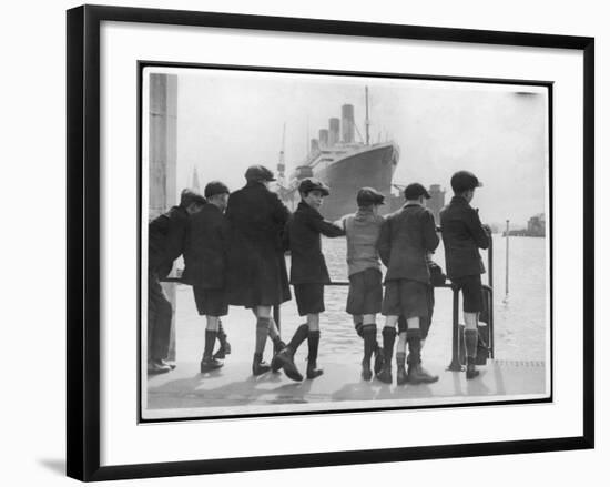 Group of Boys Lean Against the Dock Railings and Watch a Steamship Being Built-null-Framed Art Print