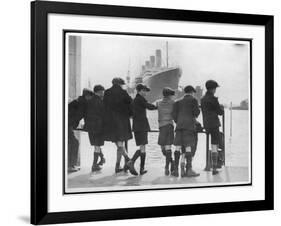 Group of Boys Lean Against the Dock Railings and Watch a Steamship Being Built-null-Framed Art Print