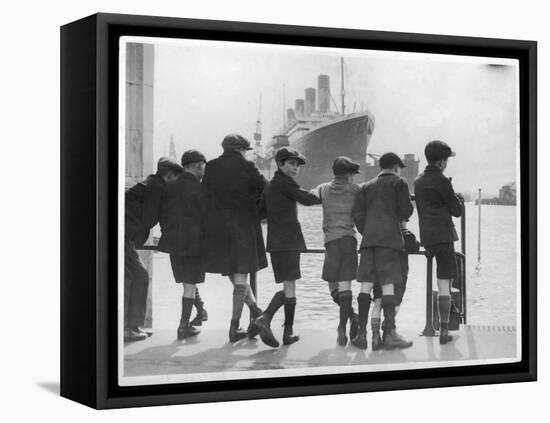 Group of Boys Lean Against the Dock Railings and Watch a Steamship Being Built-null-Framed Stretched Canvas