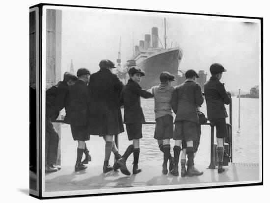 Group of Boys Lean Against the Dock Railings and Watch a Steamship Being Built-null-Stretched Canvas