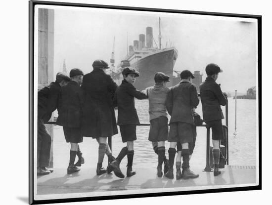 Group of Boys Lean Against the Dock Railings and Watch a Steamship Being Built-null-Mounted Art Print