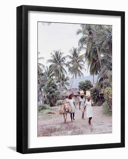 Group of Haitian Woman and a Donkey Walking Down a Dirt Road-Lynn Pelham-Framed Premium Photographic Print