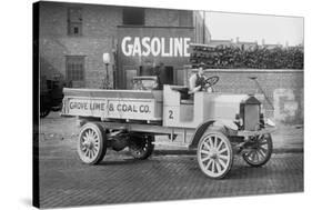 Grove Lime and Coal Company in Front of a Building Sign That Reads Gasoline-null-Stretched Canvas