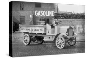 Grove Lime and Coal Company in Front of a Building Sign That Reads Gasoline-null-Stretched Canvas