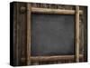 Grunge Blackboard Hanging on Wooden Wall as a Background-Andrey_Kuzmin-Stretched Canvas