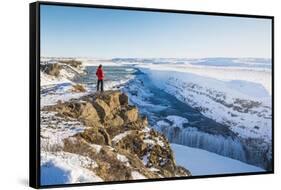 Gullfoss waterfall, Golden Circle, Iceland. Man with red coat admiring the waterfall (MR)-Marco Bottigelli-Framed Stretched Canvas