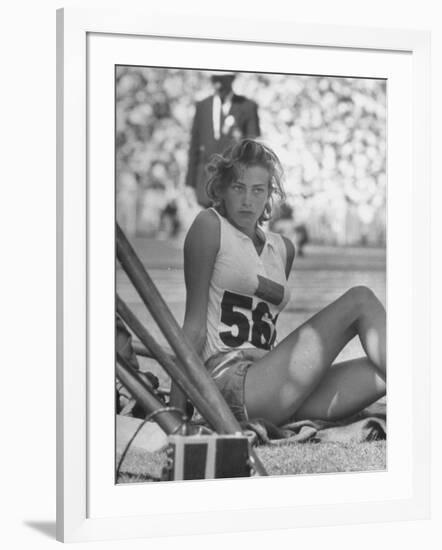 Gunhild Larking, Sweden's Entry for High Jump, Nervously Awaiting Turn to Compete at Olympic Games-George Silk-Framed Premium Photographic Print