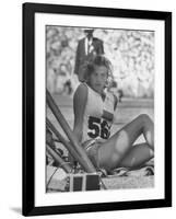 Gunhild Larking, Sweden's Entry for High Jump, Nervously Awaiting Turn to Compete at Olympic Games-George Silk-Framed Premium Photographic Print