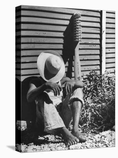 Haitian Native Engaged in a Siesta Next to Giant American Toothbrush Ad He Totes Around the Streets-Rex Hardy Jr.-Stretched Canvas