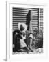 Haitian Native Engaged in a Siesta Next to Giant American Toothbrush Ad He Totes Around the Streets-Rex Hardy Jr.-Framed Photographic Print