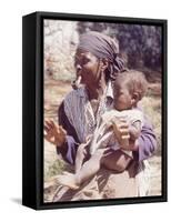 Haitian Woman Smoking a Pipe while Holding a Baby-Lynn Pelham-Framed Stretched Canvas