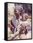 Haitian Woman Smoking a Pipe while Holding a Baby-Lynn Pelham-Framed Stretched Canvas