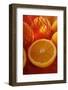 Half an Orange in Front of Oranges in Net-Foodcollection-Framed Photographic Print