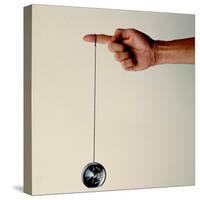 Hand Holding String Attached to Tom Khun Yo-Yos Ltd's High-Tech, Aluminum, Ball Bearing Yo-Yo-Ted Thai-Stretched Canvas