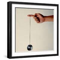 Hand Holding String Attached to Tom Khun Yo-Yos Ltd's High-Tech, Aluminum, Ball Bearing Yo-Yo-Ted Thai-Framed Photographic Print