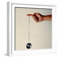 Hand Holding String Attached to Tom Khun Yo-Yos Ltd's High-Tech, Aluminum, Ball Bearing Yo-Yo-Ted Thai-Framed Photographic Print