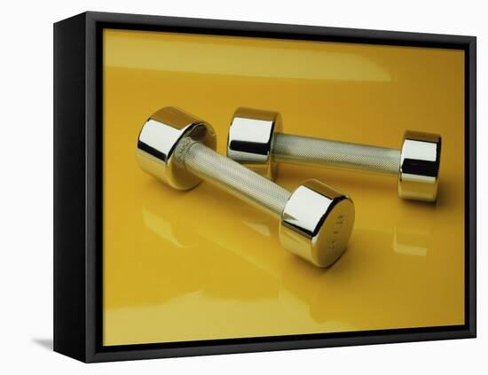 Hand Weights on a Reflective Yellow Surface-null-Framed Stretched Canvas