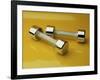 Hand Weights on a Reflective Yellow Surface-null-Framed Photographic Print