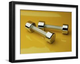 Hand Weights on a Reflective Yellow Surface-null-Framed Photographic Print