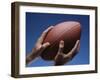 Hands Holding Football with Blue Background-null-Framed Photographic Print