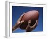 Hands Holding Football with Blue Background-null-Framed Photographic Print