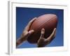 Hands Holding Football with Blue Background-null-Framed Photographic Print