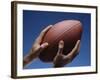 Hands Holding Football with Blue Background-null-Framed Photographic Print