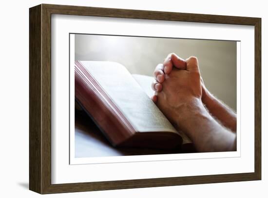 Hands Praying on a Holy Bible-null-Framed Art Print