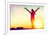 Happy Celebrating Winning Success Woman at Sunset or Sunrise Standing Elated with Arms Raised up Ab-Maridav-Framed Photographic Print