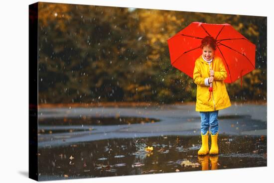 Happy Child Girl with an Umbrella and Rubber Boots in Puddle on an Autumn Walk-null-Stretched Canvas