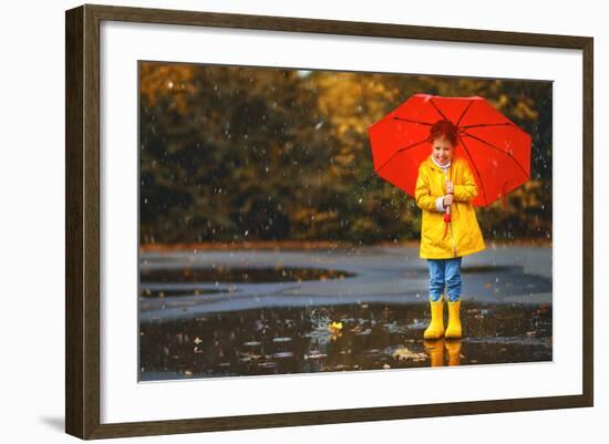 Happy Child Girl with an Umbrella and Rubber Boots in Puddle on an Autumn Walk-null-Framed Photographic Print