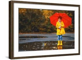 Happy Child Girl with an Umbrella and Rubber Boots in Puddle on an Autumn Walk-null-Framed Photographic Print