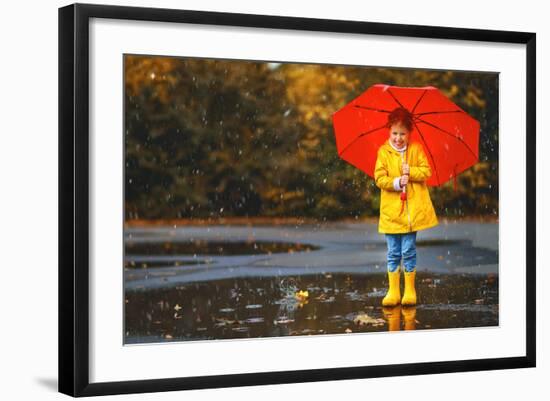 Happy Child Girl with an Umbrella and Rubber Boots in Puddle on an Autumn Walk-null-Framed Photographic Print