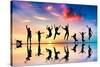 Happy Group Of Friends, Family With Dog And Cat Jumping Together At Sunset, Water Reflection-Michal Bednarek-Stretched Canvas