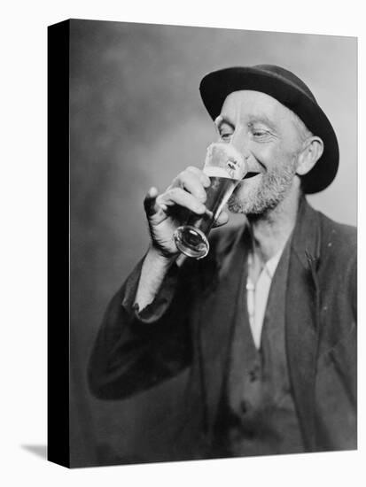Happy Old Man Drinking Glass of Beer, with His Daintier Finger Extended. 1937-null-Stretched Canvas