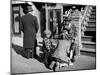 Harlem Street Scene Showing a Man Getting a Shoeshine as a Young Child Watches Intently-null-Mounted Photographic Print