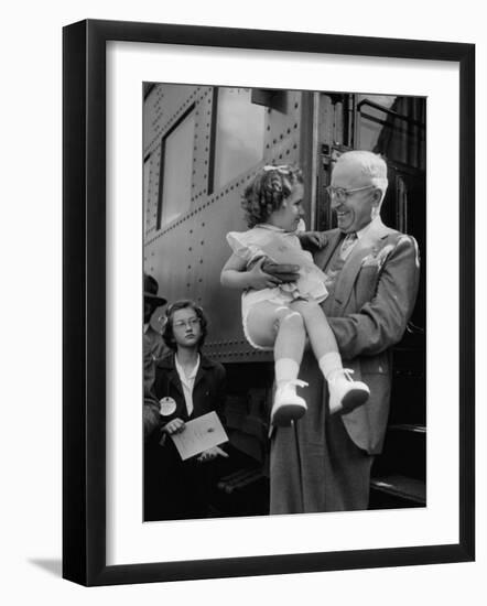 Harry Truman Holding up 3 Yr Old Suzanne Bump after the Town's Postmaster Pressed Her into Service-Hank Walker-Framed Photographic Print