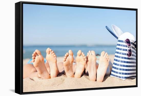 Hats and Summer Concept - Three Women Lying on the Beach with Straw Hat, Sunglasses and Bag-dolgachov-Framed Stretched Canvas