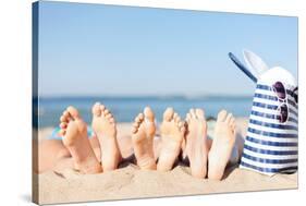 Hats and Summer Concept - Three Women Lying on the Beach with Straw Hat, Sunglasses and Bag-dolgachov-Stretched Canvas