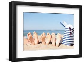 Hats and Summer Concept - Three Women Lying on the Beach with Straw Hat, Sunglasses and Bag-dolgachov-Framed Photographic Print