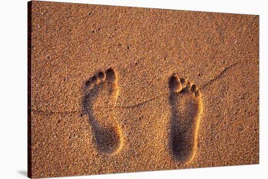 Hawaii, Kauai. Footprints in the sand on a Hawaii beach.-Janis Miglavs-Stretched Canvas