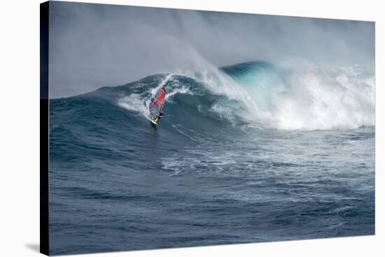 Hawaii, Maui. Lone Figure Windsurfing Monster Waves at Pe'Ahi Jaws, North Shore Maui-Janis Miglavs-Stretched Canvas