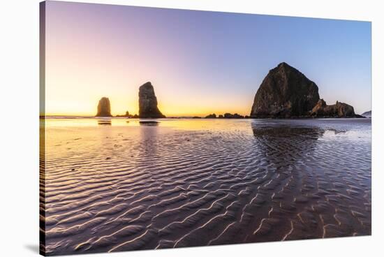 Haystack Rock and The Needles at sunset, with textured sand in the foreground-francesco vaninetti-Stretched Canvas