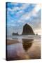 Haystack Rock reflected on the shoreline at Cannon Beach on the Pacific Northwest coast, Oregon, Un-Martin Child-Stretched Canvas